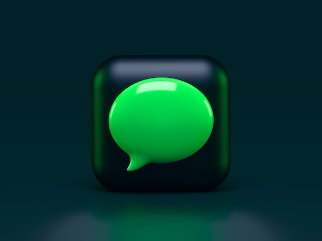 Ilustrasi 3D kotak pesan berwarna hijau di atas ubin hitam yang dikelilingi latar belakang hitam.