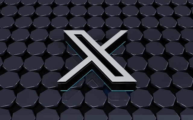Render 3D logo baru Twitter dengan latar belakang abu-abu dengan beberapa heptagon.