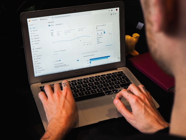 Un uomo guarda il cruscotto di Google Analytics per il suo sito web.
