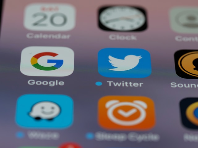 Twitterを含む複数のアプリケーションタイルが表示された携帯電話画面のクローズアップ画像。