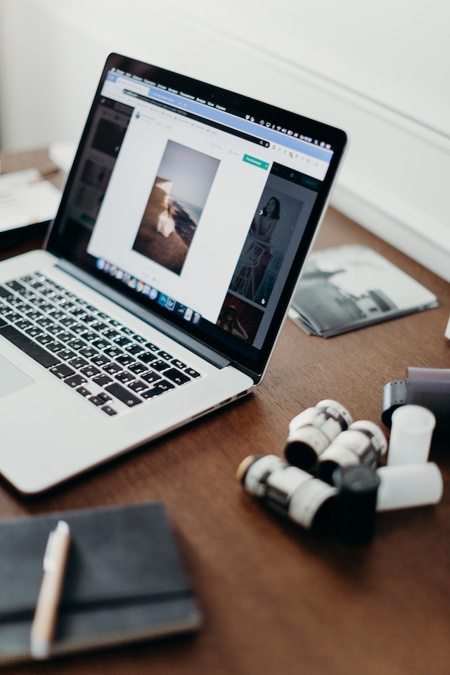 An image from a website opened on a MacBook Pro on a wooden table.