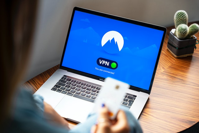 A photograph depicting a Twitter user connected to VPN on a laptop device.