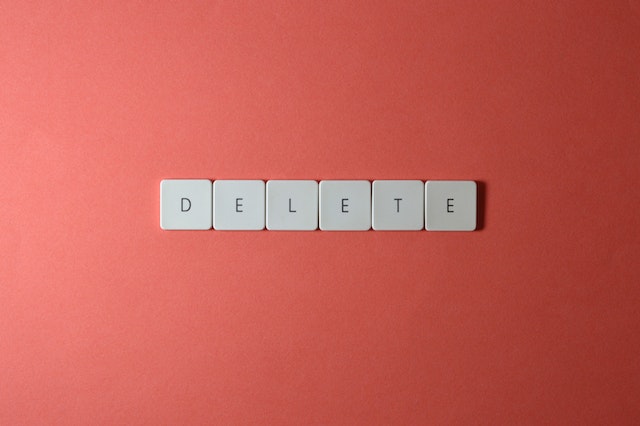 An image of several white buttons with alphabets spelling out “DELETE.”