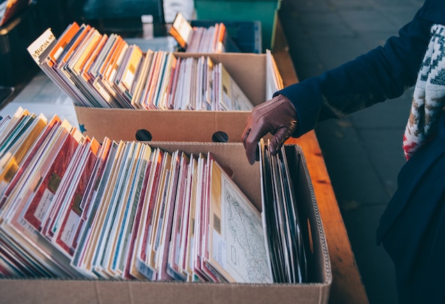 A photo of someone standing beside boxes of files.