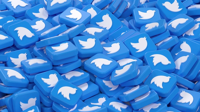 An illustration of many blue boxes with engraved Twitter logos piled on themselves.