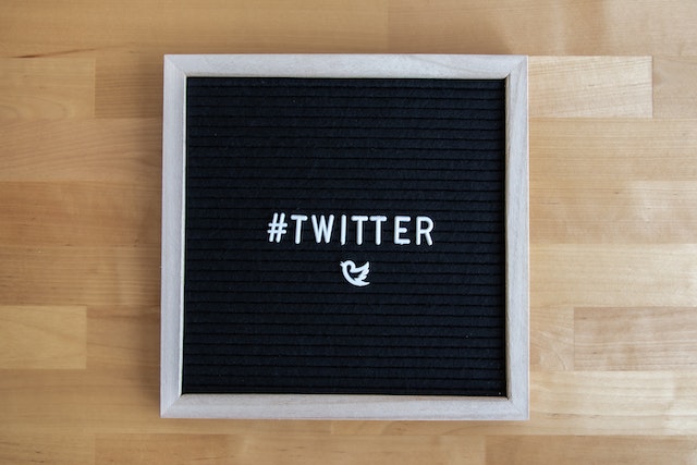 A picture of the word '#Twitter' and the bird logo on a blackboard.