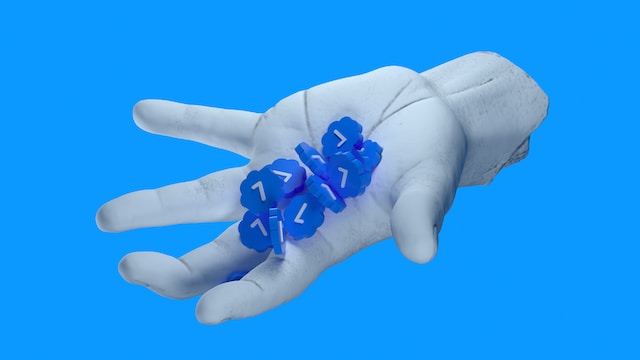 A 3D image of a cut hand holding Twitter’s verified badges like pills on an open palm.
