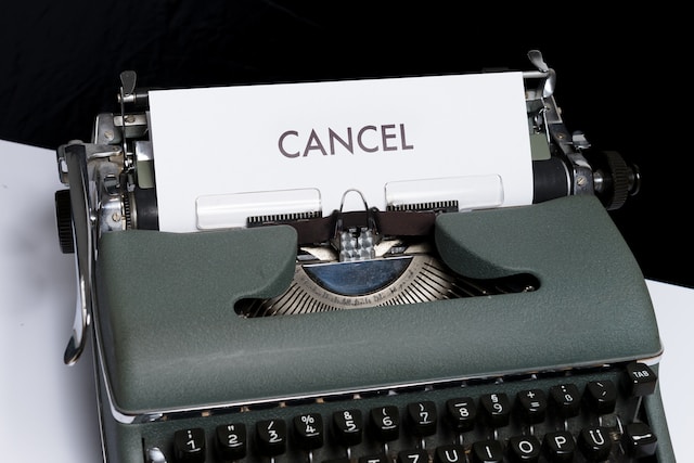 A photograph of a typewriter with a paper in it carrying the heading “CANCEL.”