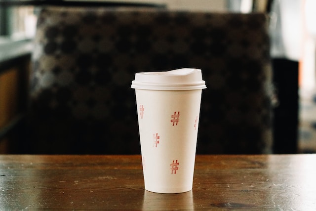 A picture of a styrofoam cup on a table with the hash symbol printed all over it.