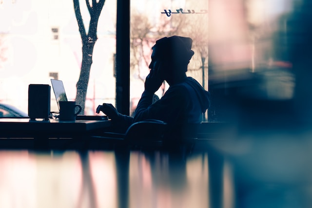 A silhouetted photographer using reverse photo search to see if anyone uses their images without permission.