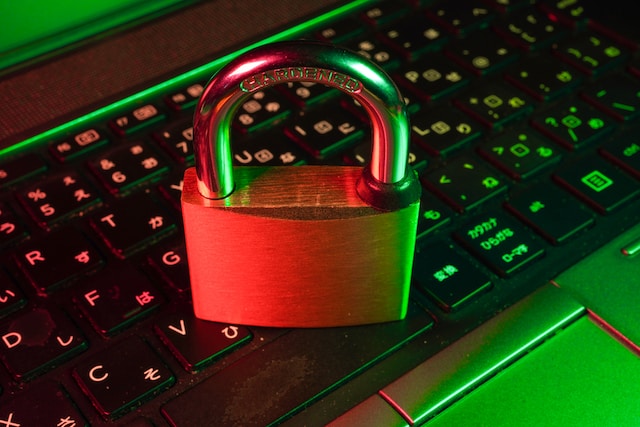A closeup picture of a locked padlock placed on a laptop keyboard. 