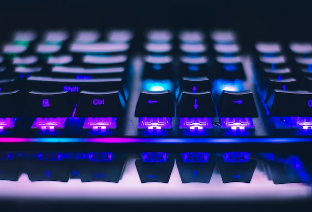 A picture of a close-up view of an illuminated computer keyboard.