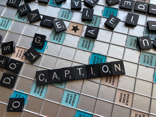 The word “caption” on a Scrabble board.
