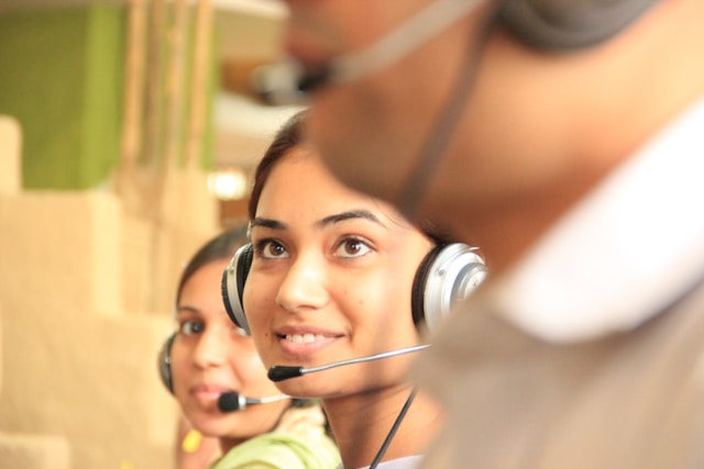 A closeup of a woman wearing a headset.
