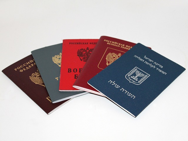 Five passport booklets spread out on a table.
