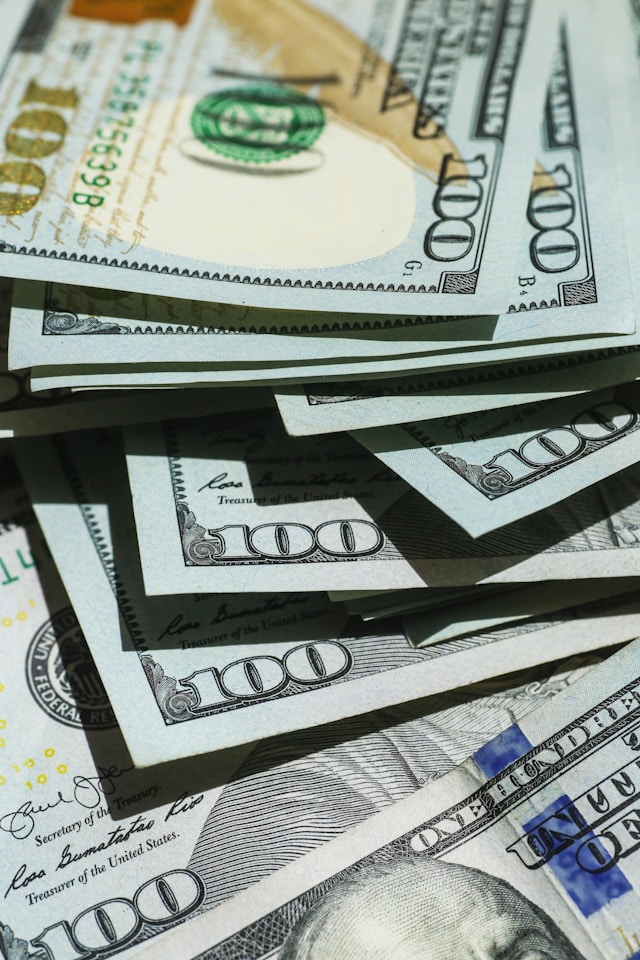 A close-up of multiple hundred dollar bills.