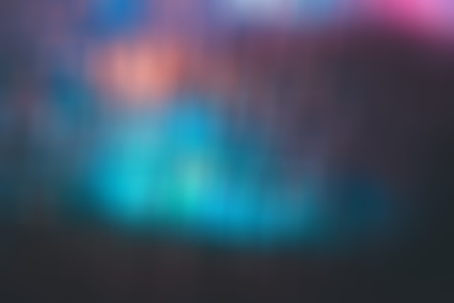 A blurry background with shades of blue, green, orange, red, and purple.