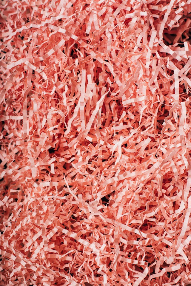 A close-up of red shredded paper.
