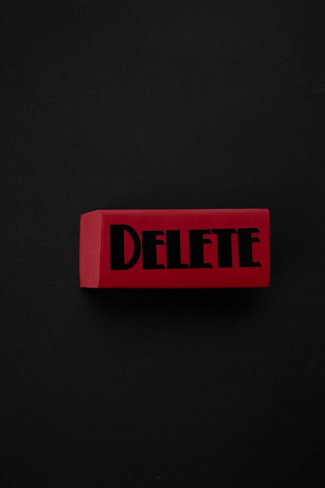 A red block with the phrase “Delete” in black font on a black background.