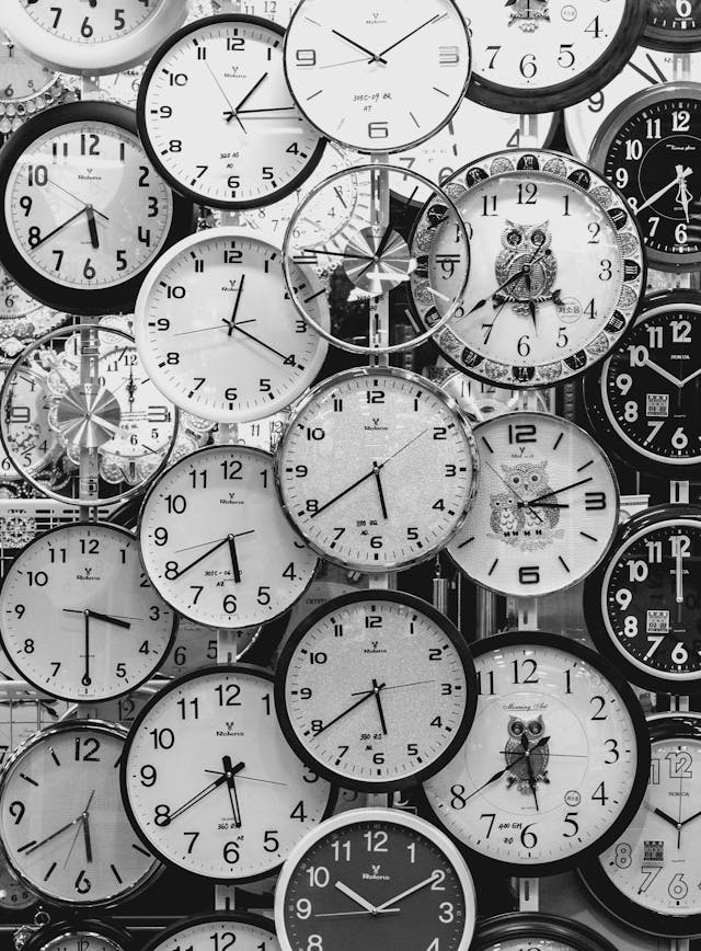 A close-up of a collection of clocks in different styles.