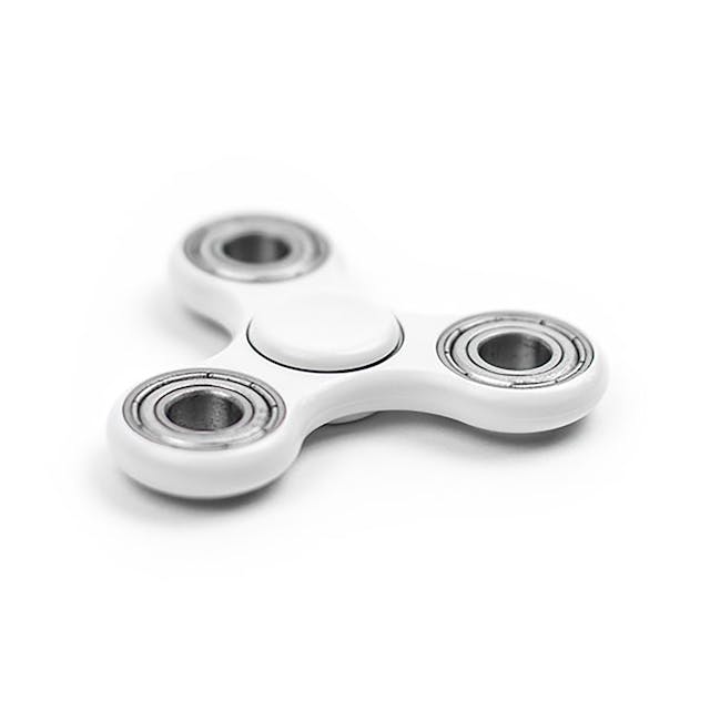 A close-up of a white fidget spinner.