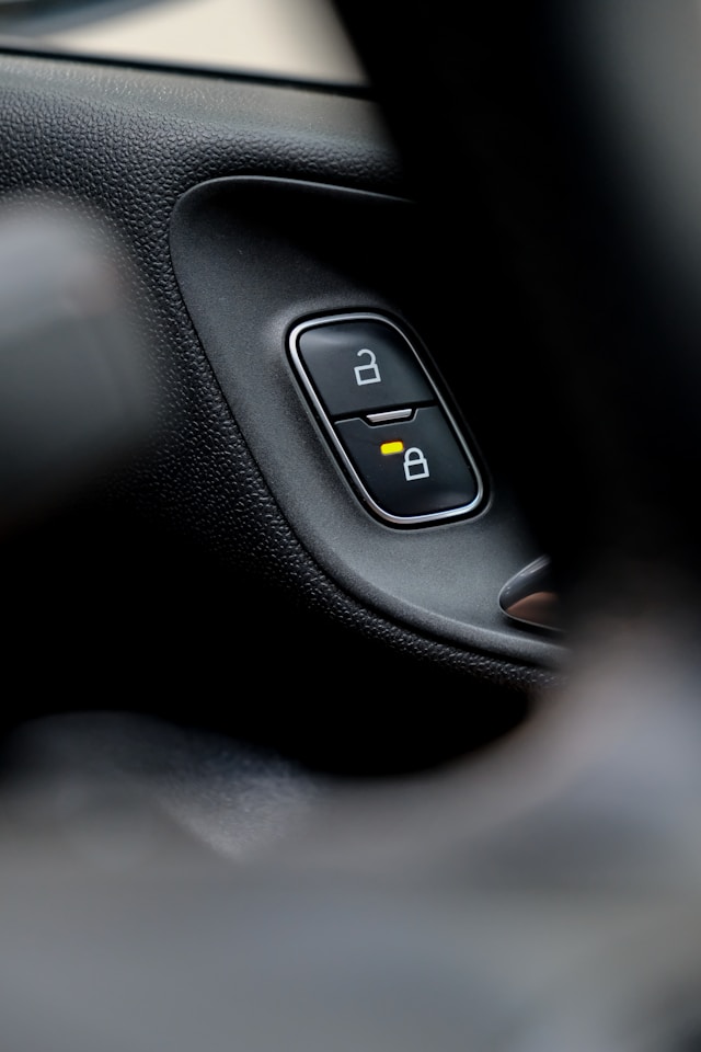 A close-up of a lock and unlock button in a car.